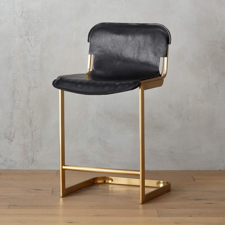 Black leather stool with brass