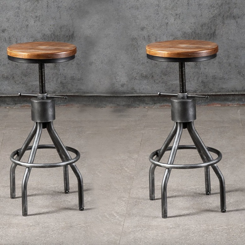 two industrial bar stools in a gray room