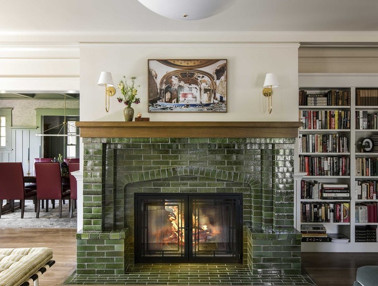 green tile fireplace in a green and white living room