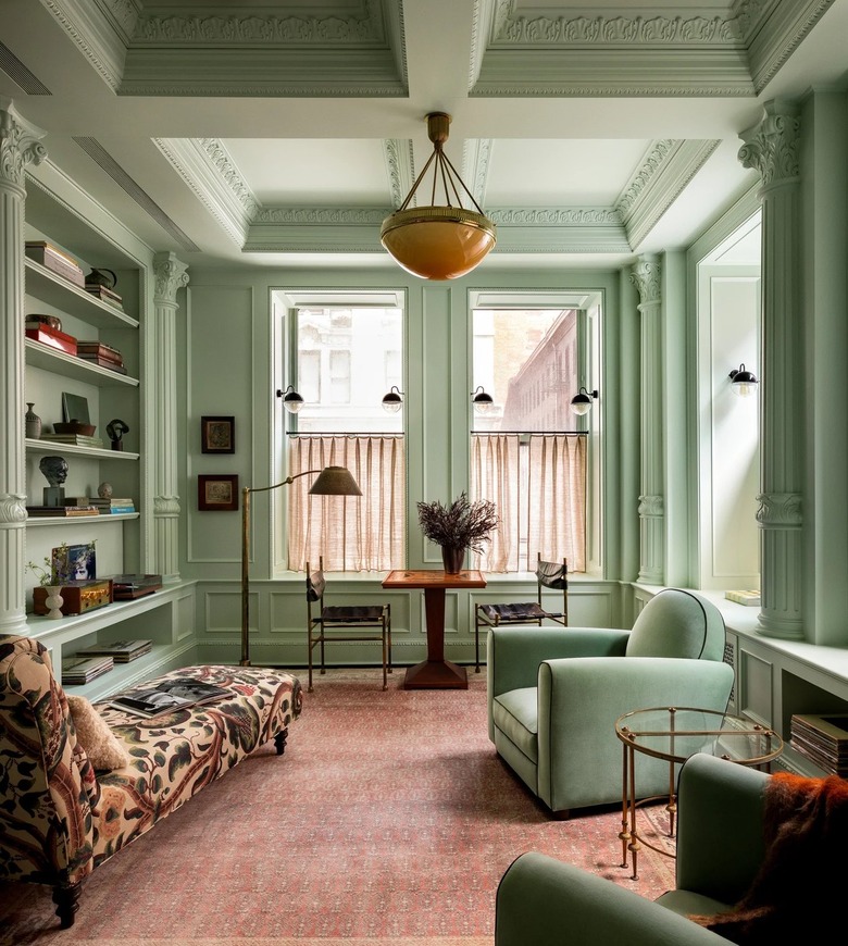sage green living room with terra cotta rug
