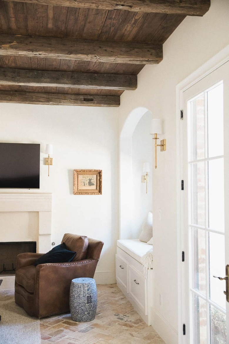 french country living room with wooden beam ceilings
