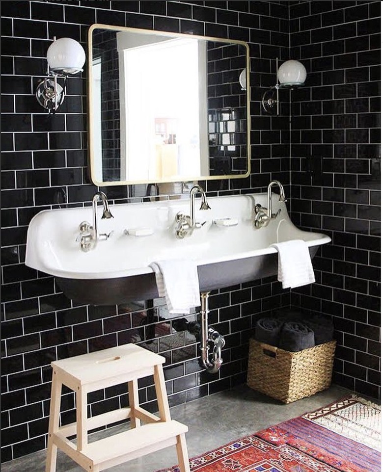 Industrial bathroom with black subway tile.