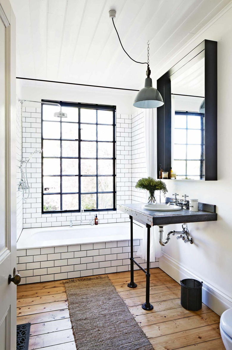 industrial bathroom with subway wall tile and pedestal sink