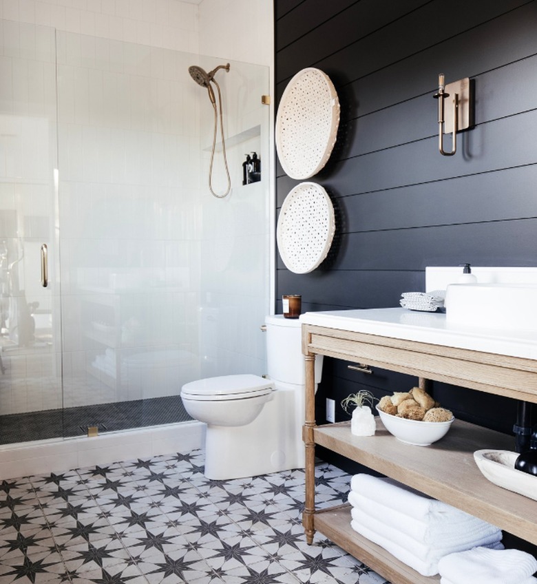 Industrial bathroom with black walls and patterned floors