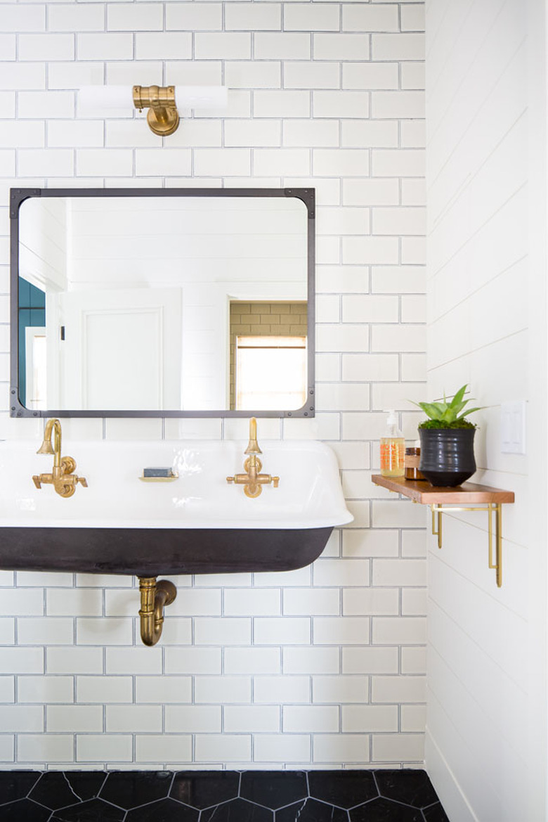Industrial bathroom with utility sink and subway tile
