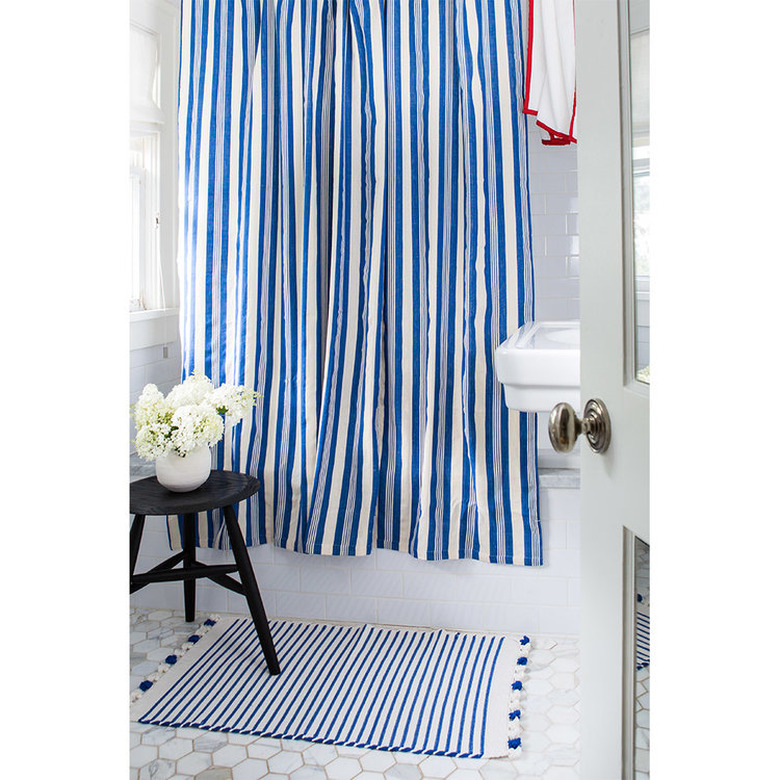 blue and white stripe shower curtain in coastal bathroom
