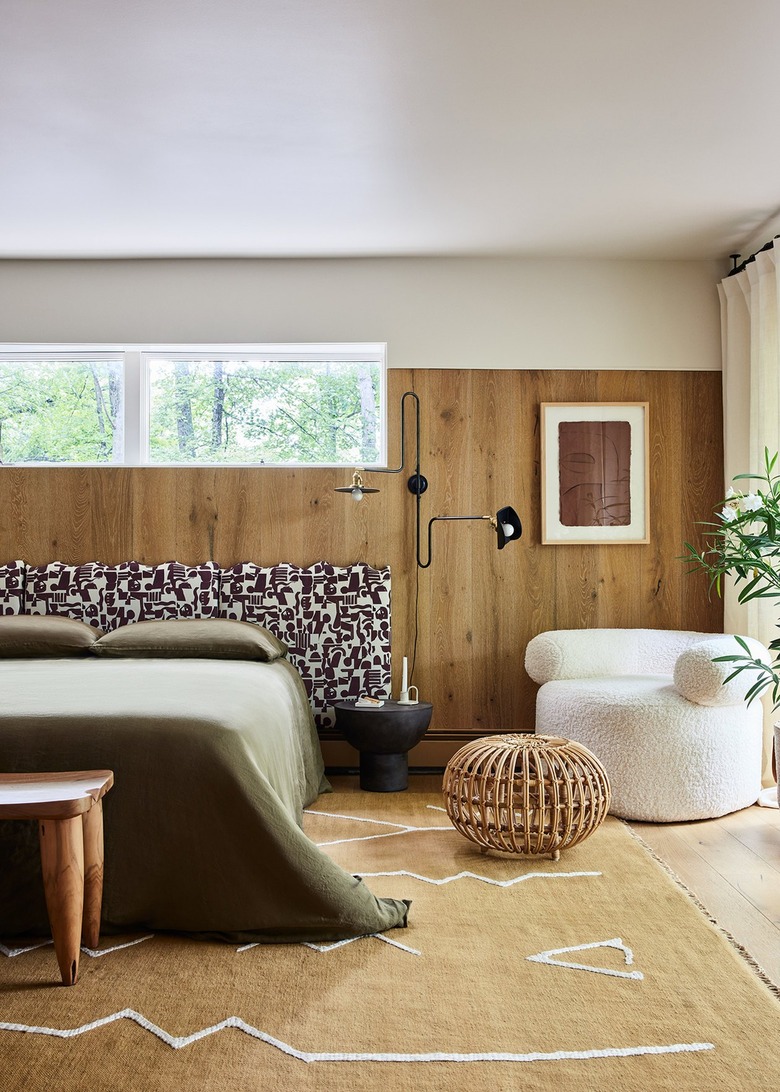 bedroom with black double-arm sconces next to headboard