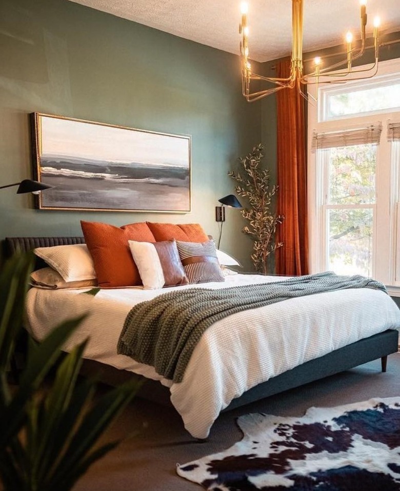 Earth-tone bedroom with accent gold chandelier