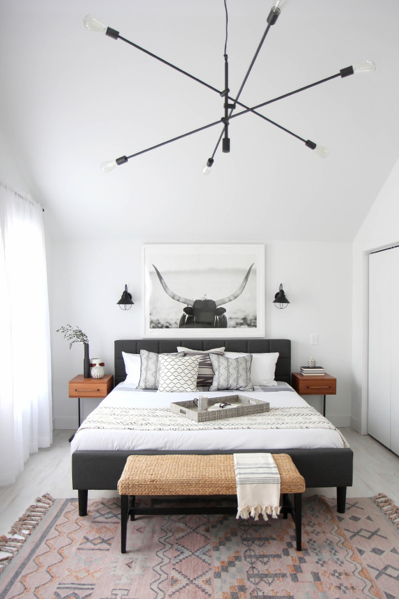 sputnik chandelier in bedroom hanging over bed