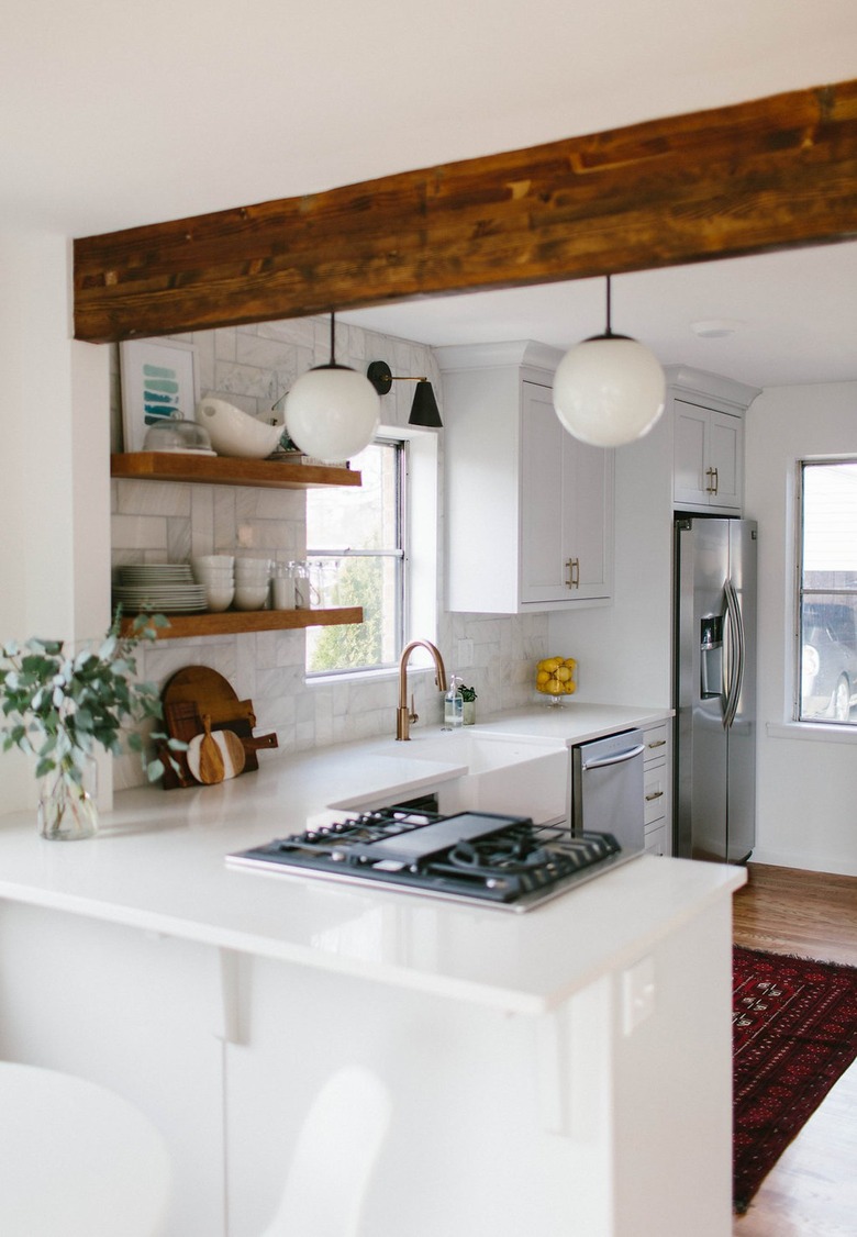 white midcentury l-shaped kitchen with wood beams
