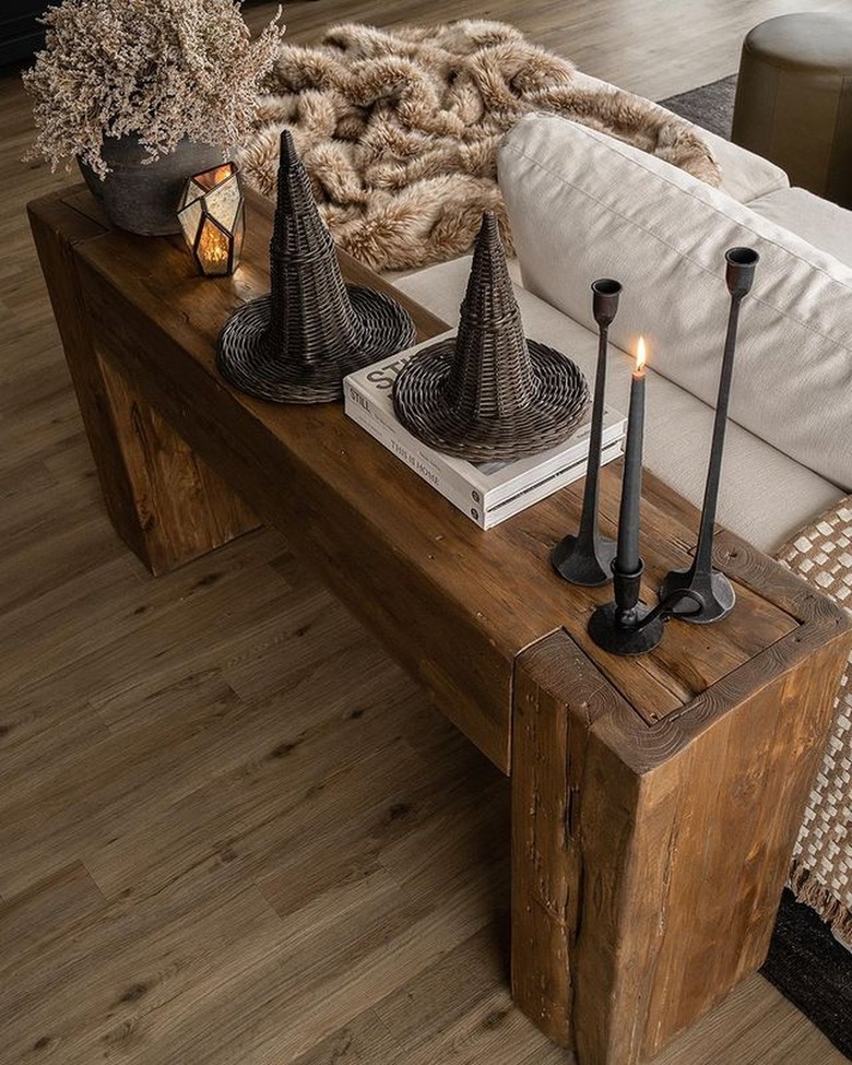 Rustic wooden table with wicker witch hats