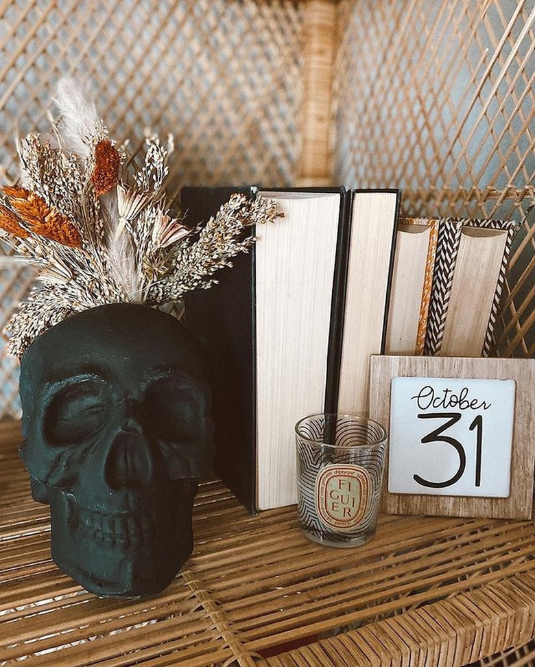 Black faux skull on rattan shelf