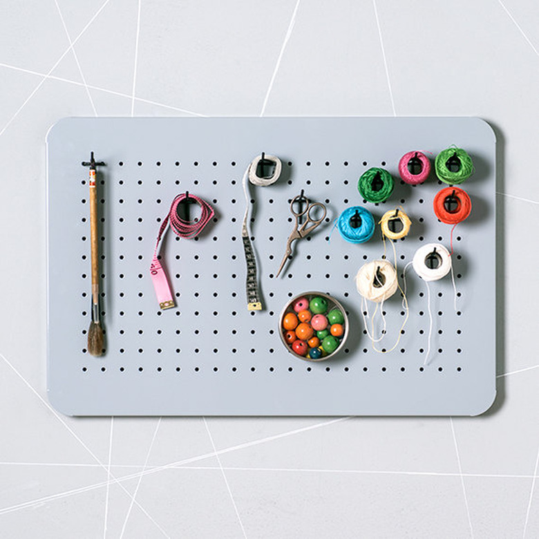 Einadesign gray pegboard with craft items.