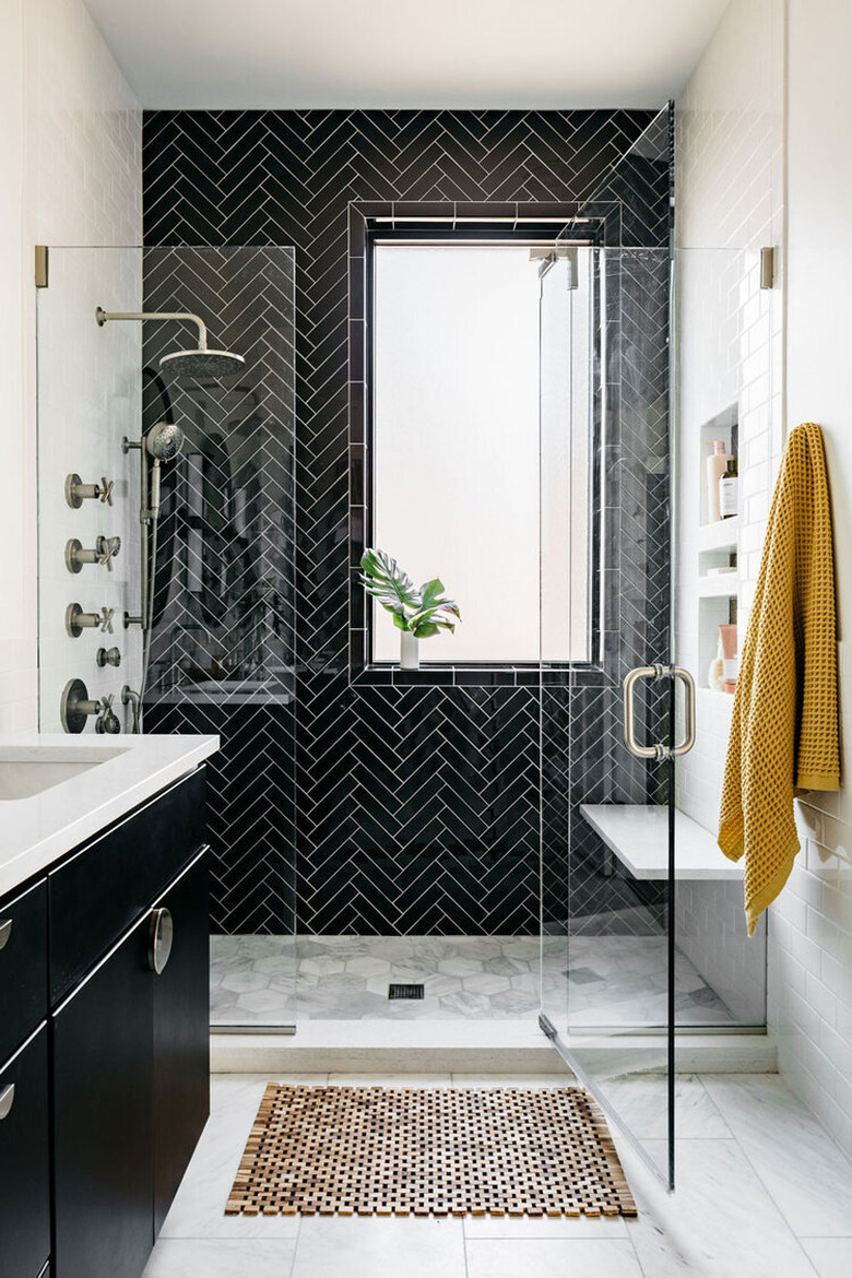 black and white bathroom with herringbone tile accent wall