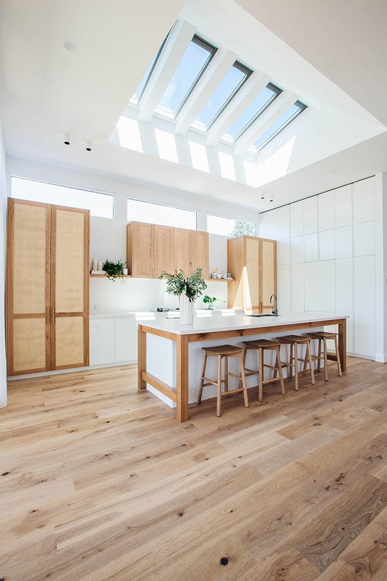 open kitchen with skylights and wood flooring