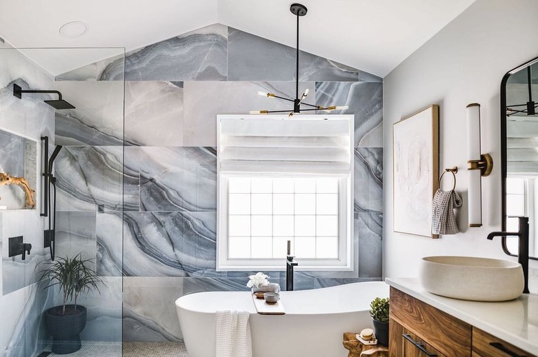 midcentury and contemporary bathroom with marble tile wall
