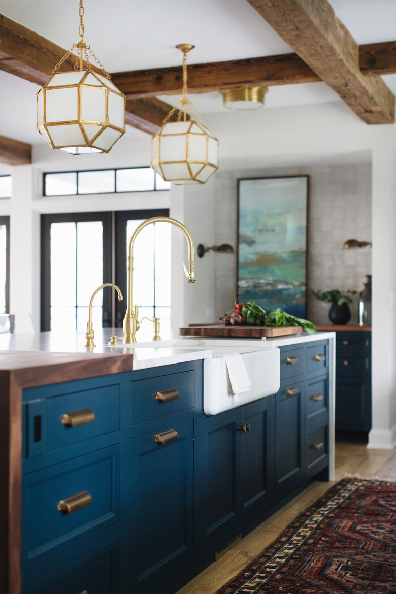 farmhouse kitchen with blue cabinets and apron sink