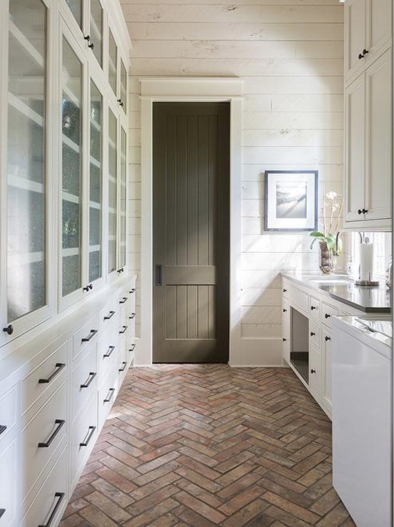 cream and khaki galley kitchen with brick floor