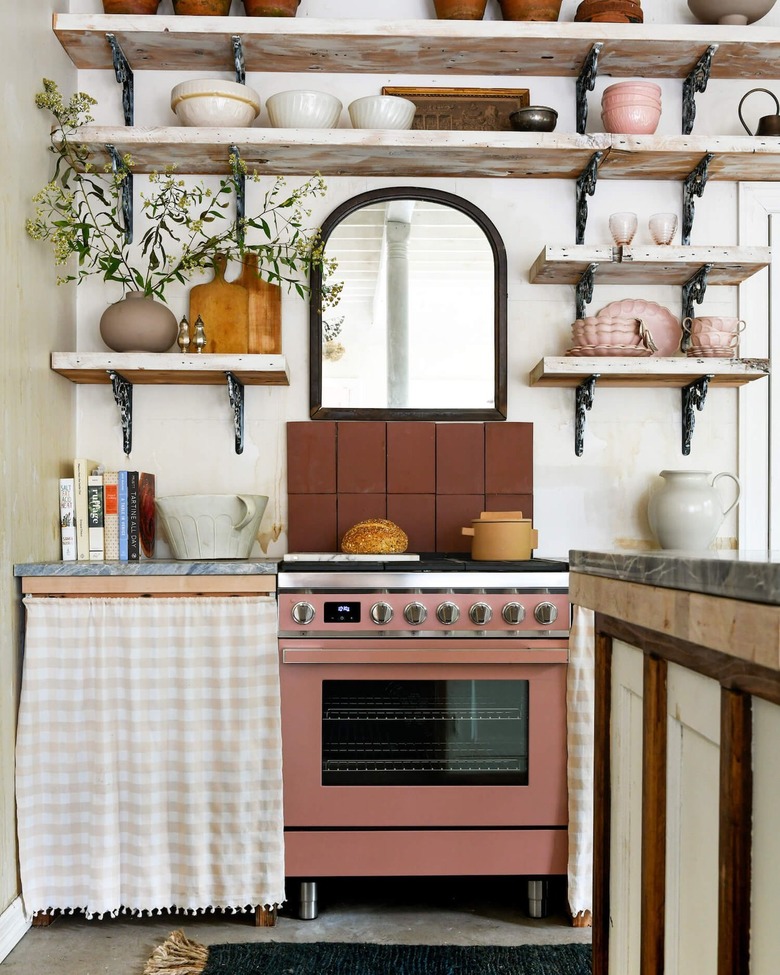 kitchen with pink stove and cabinet skirt