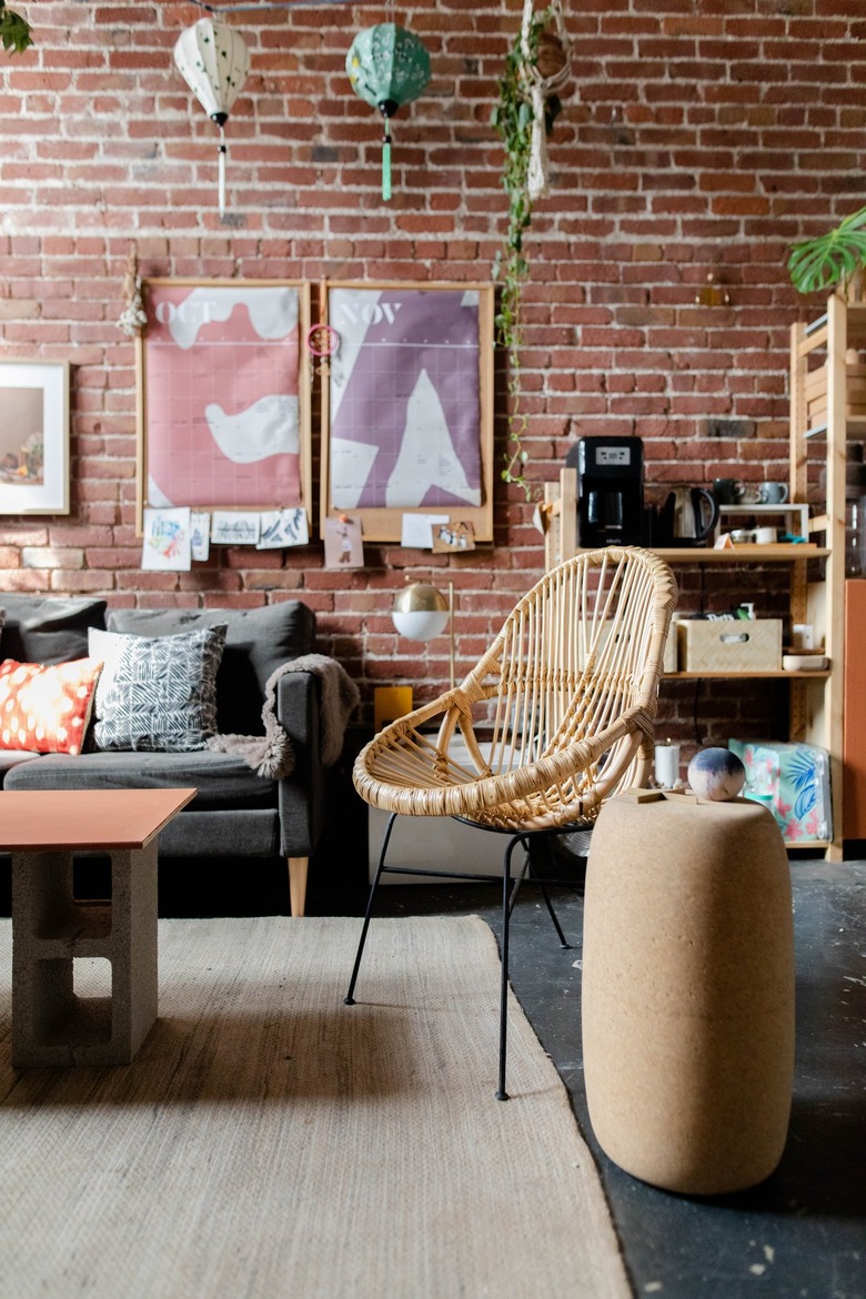 A living room with a brick wall