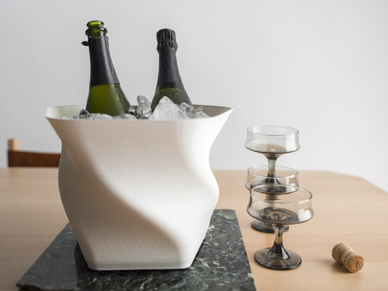 champagne in bucket with two glasses nearby