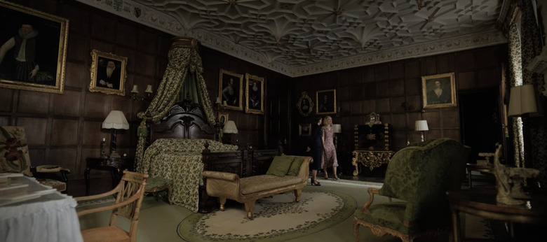 master bedroom with wooden finish walls and dark green decor