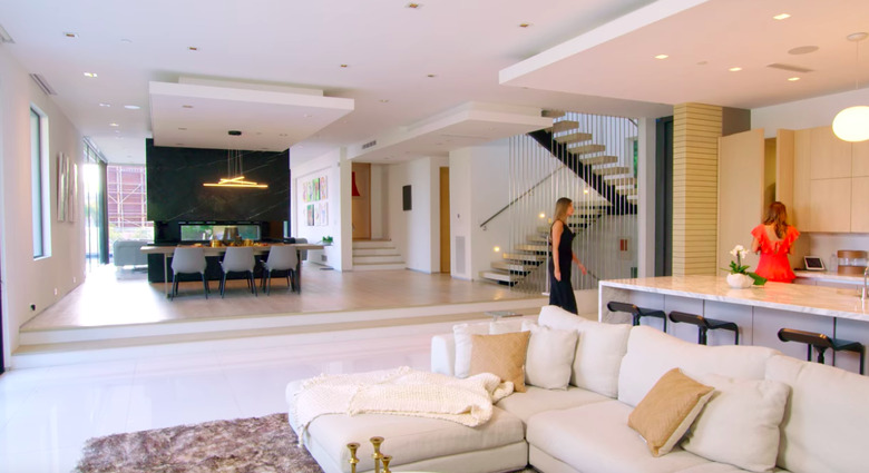 modern house interior with white couch and kitchen island nearby