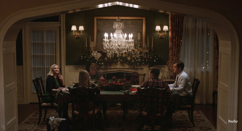 people in dining room with chandelier