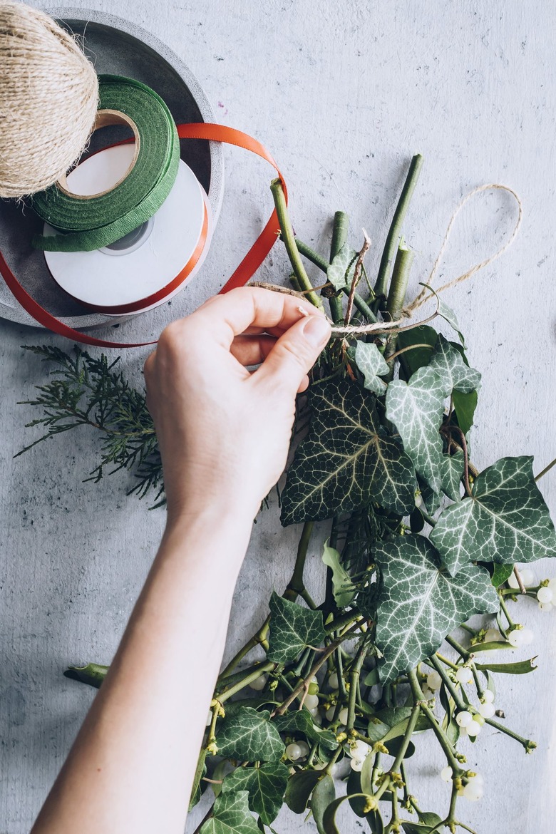 a diy bunch of mistletoe is secured with twine