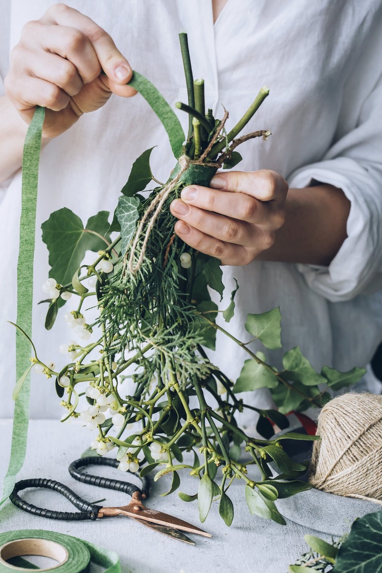 a diy bunch of mistletoe is secured with floral tape
