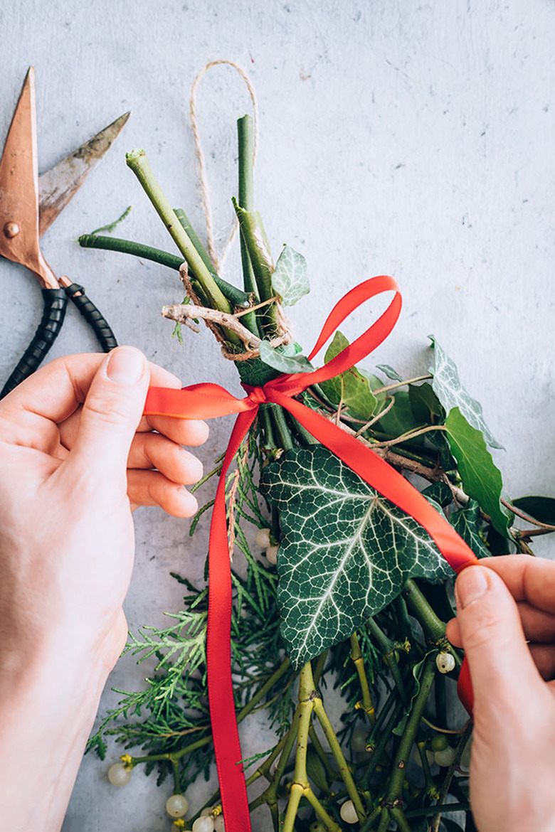 Tying a bow on mistletoe