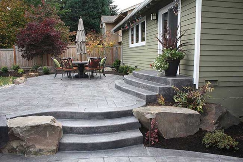 A freeform shaped stamped concrete patio with multiple levels