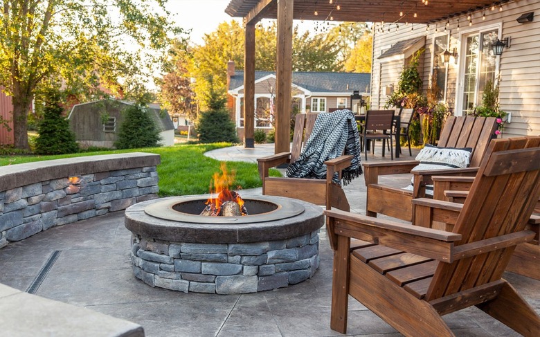 A concrete stamped patio paired with a wooden pergola