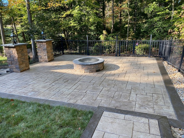 A stamped concrete patio with a dark border
