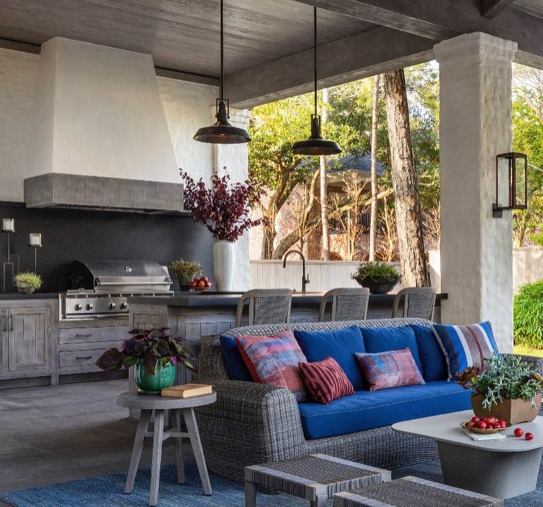 outdoor kitchen with indoor loungey furniture