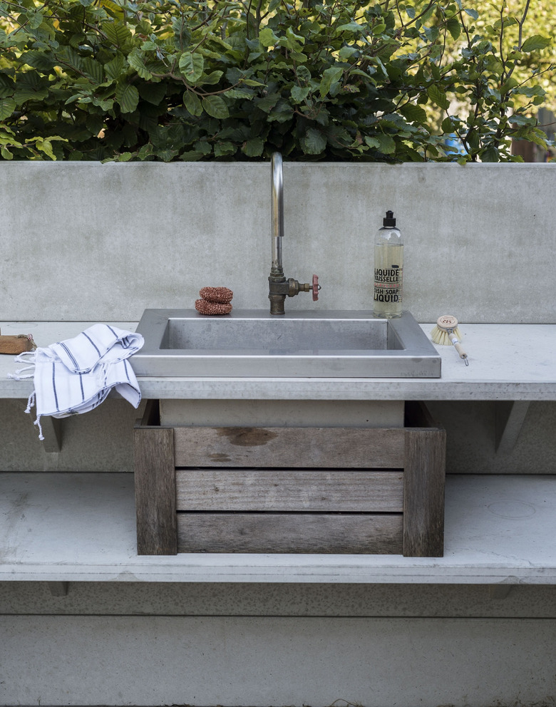 outdoor kitchen idea with concrete countertops and stainless steel sink