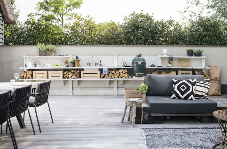 concrete sectional outdoor kitchen idea with chopped wood