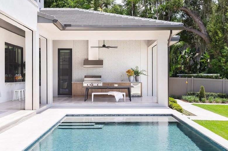 pool adjacent outdoor kitchen with fan