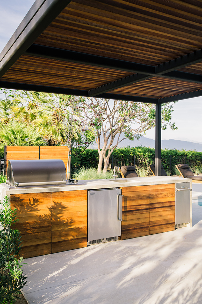 covered outdoor kitchen idea with stainless steel appliances