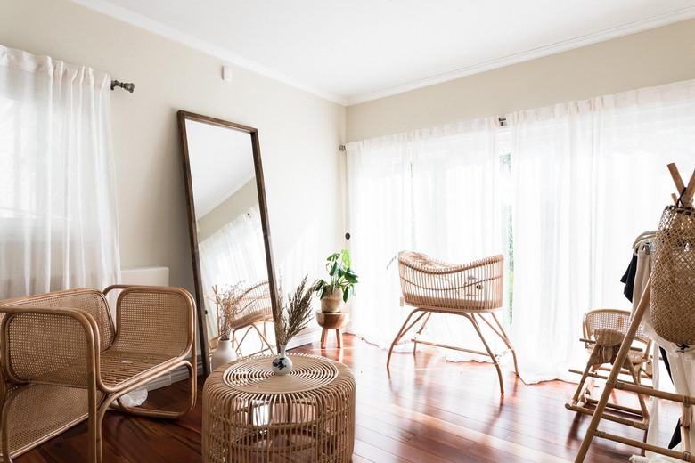Minimalist boho nursery with rattan crib