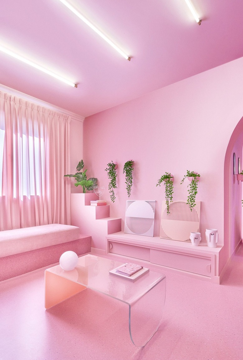 bubblegum pink living room with lucite coffee table