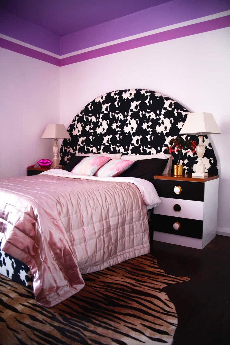 purple 80s themed bedroom with cow hide headboard