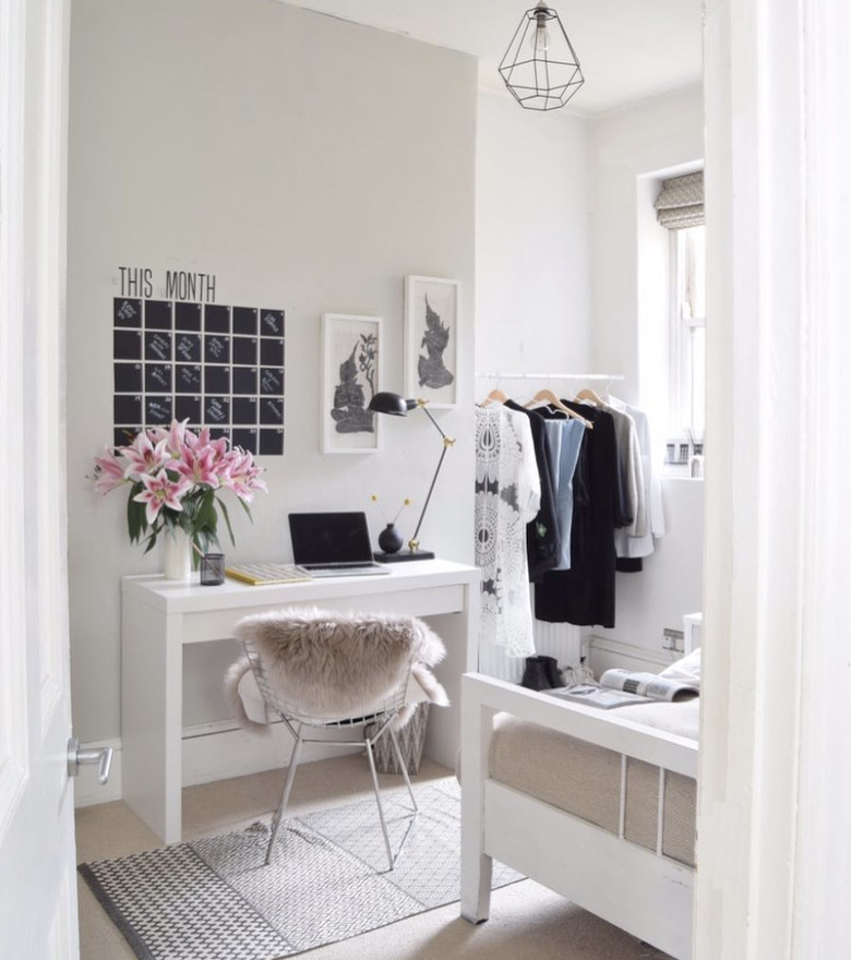 bedroom office idea with white desk with a chalkboard vinyl wall calendar on a tan wall