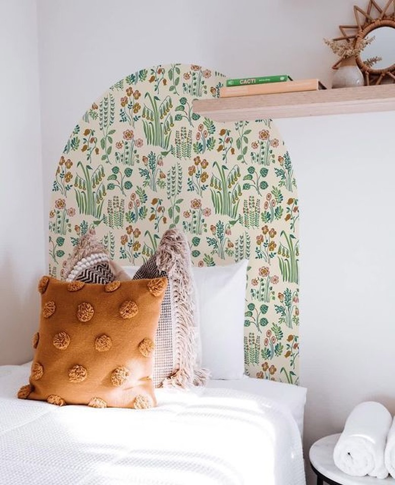white bedroom with arched wallpaper headboard
