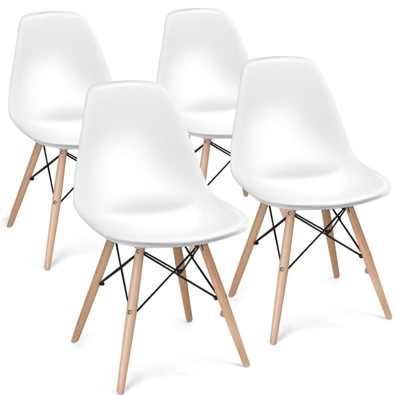 Four white armless mid-century dining chairs with wooden legs