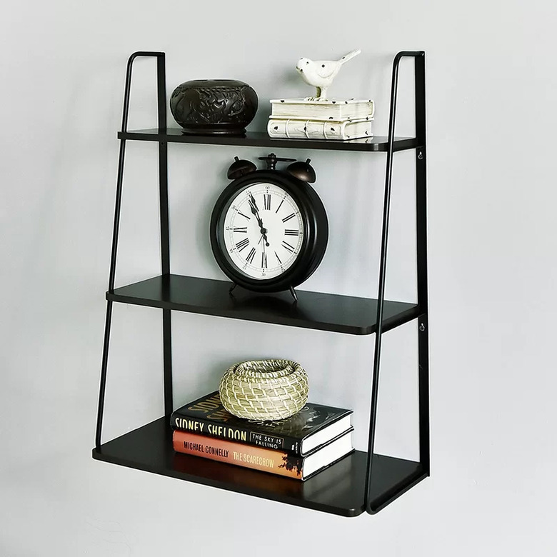 Black metal wall shelving unit with three shelves of varying sizes