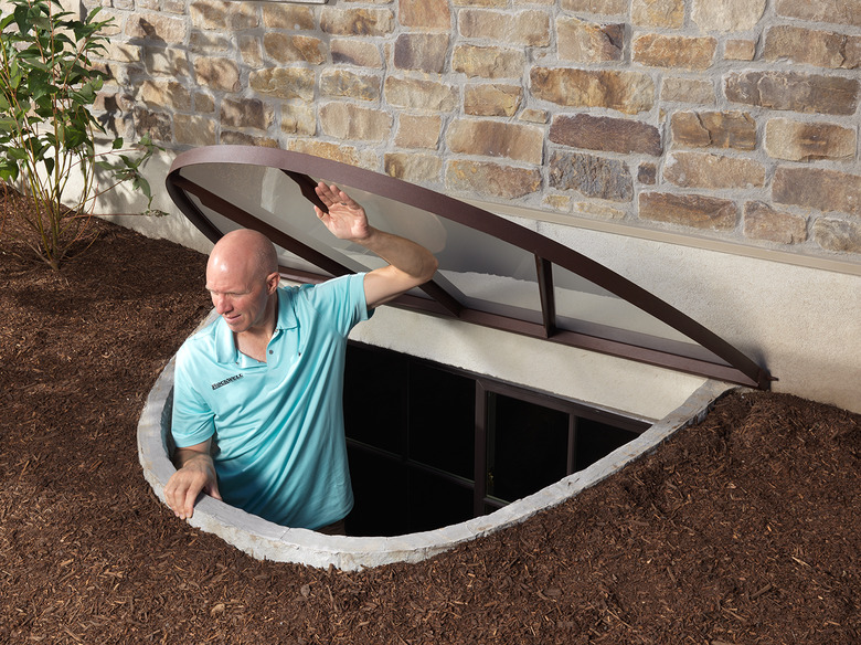 Man exiting window well.