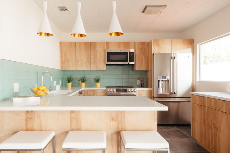 view of a kitchen with mint green tile backsplash