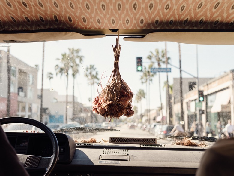 A dried bouquet hanging from a rear-view mirror