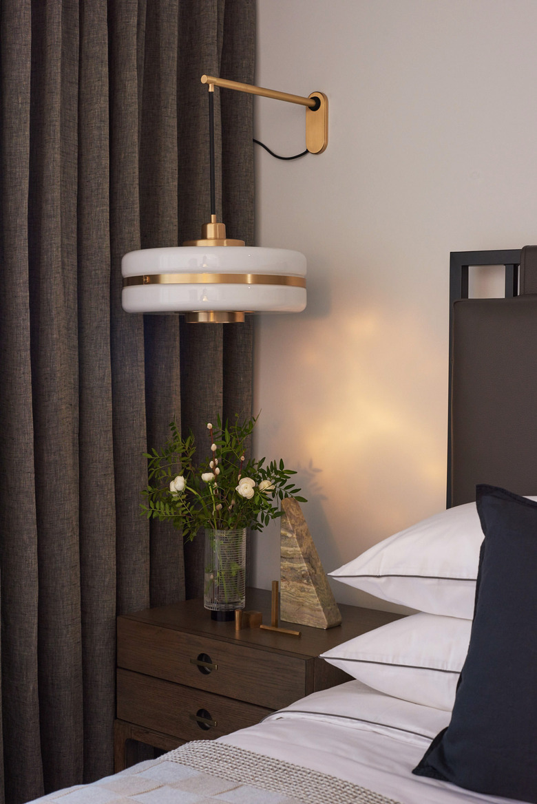 bedroom with white sheets and hanging pendant
